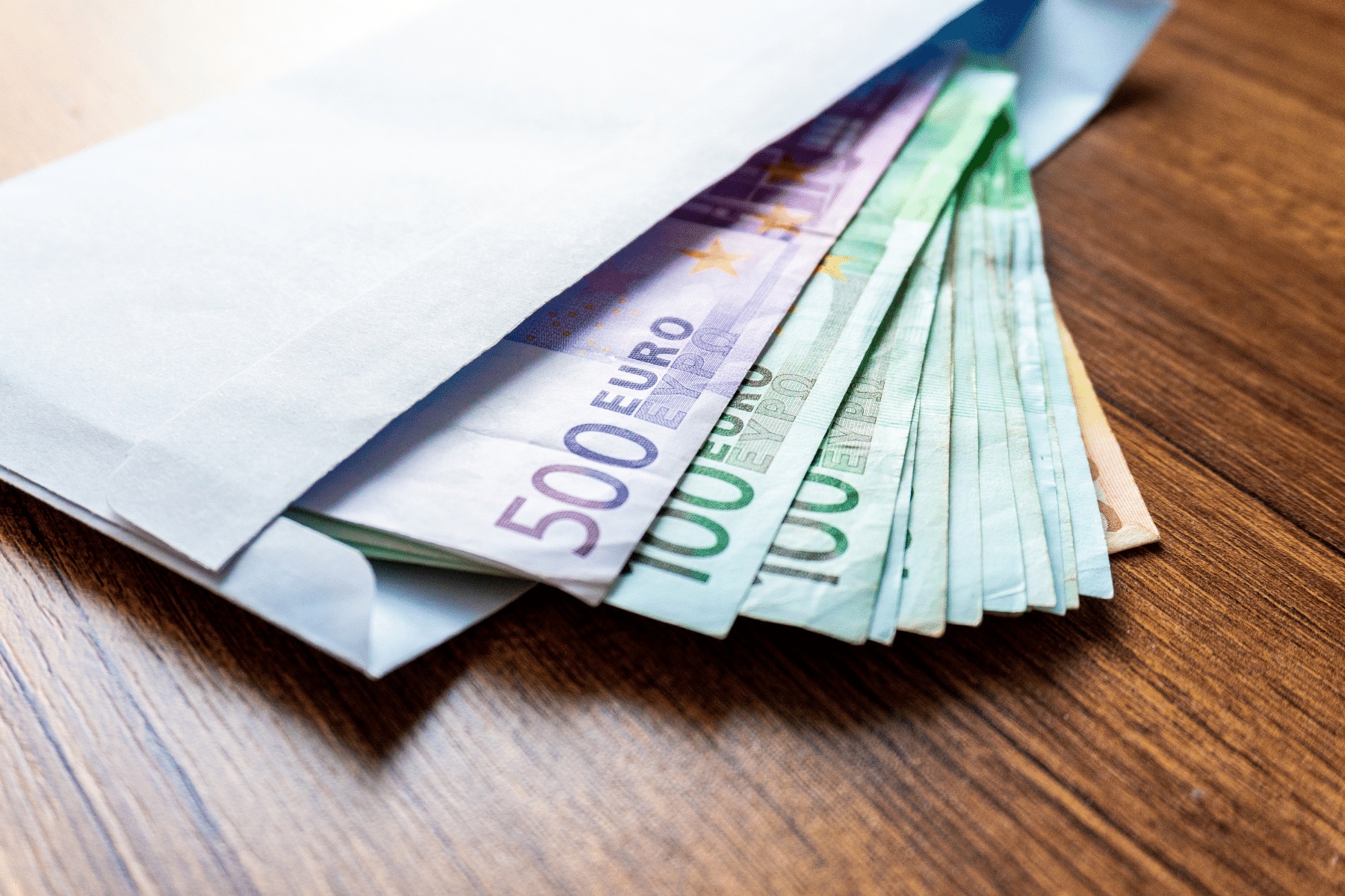 photo of a white envelope with euros coming out of it