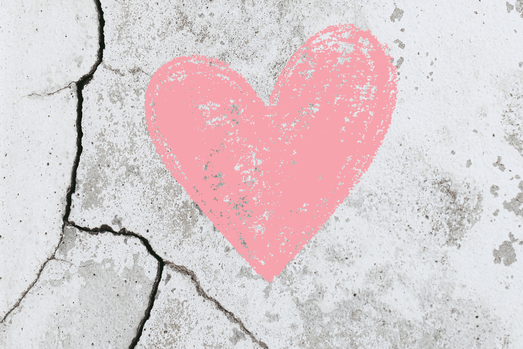 Picture of a heart drawn on cracked concrete